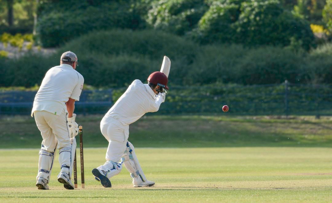 Cricket batsman preparing a shot during a match