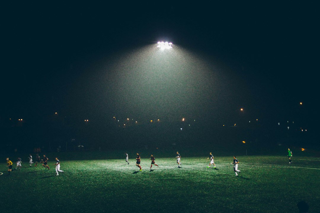 Football players in action under stadium lights